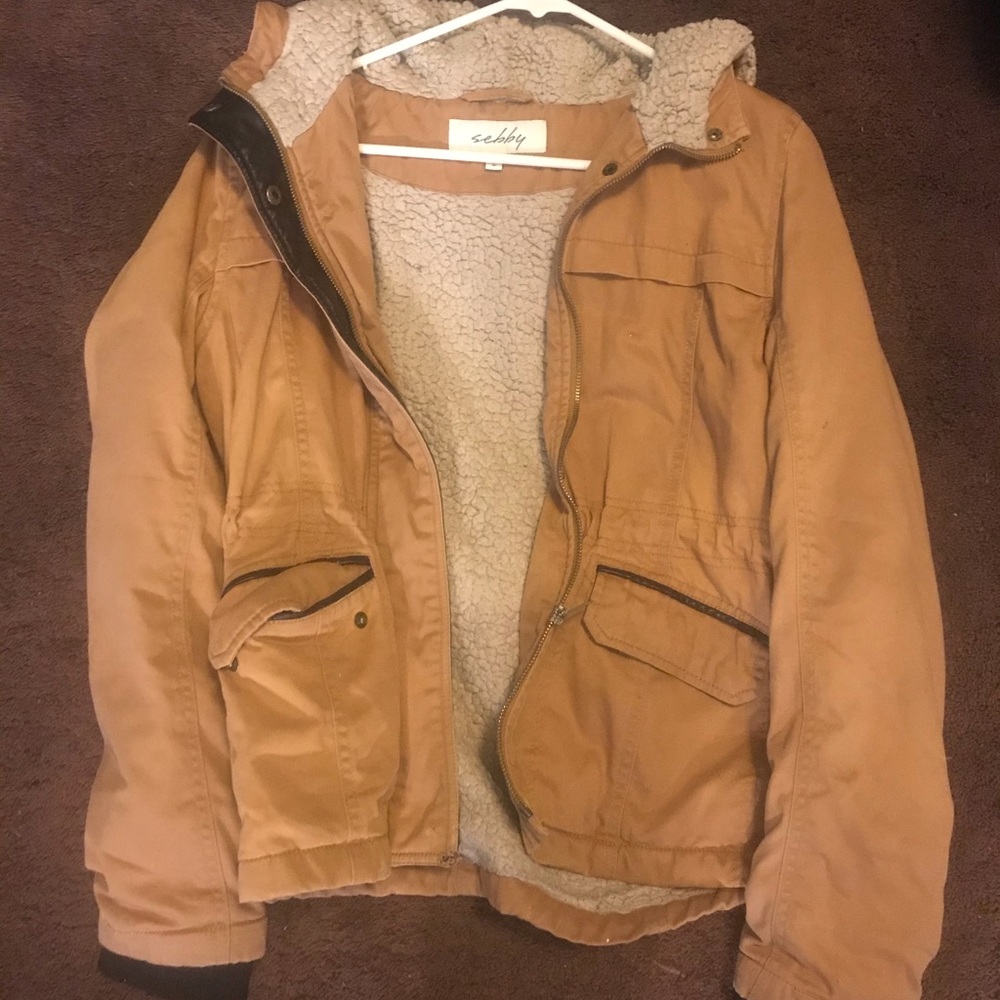 A tan zip-up jacket with Sherpa on the inside.